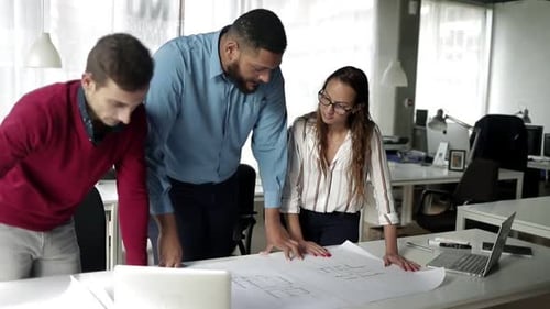 Construction Experts Discussing Building Floor Plan