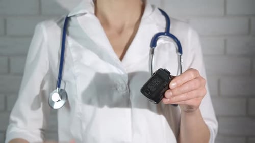 Doctor Measures Pulse Oximetry with a Medical Device