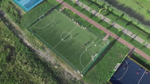 Football soccer field outdoors. People playing football at sunny summer day