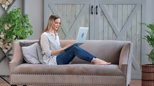 Woman Working on Laptop Computer at Home