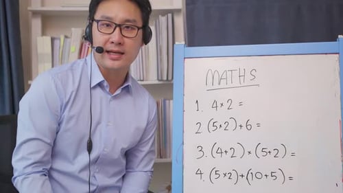 Asian school young man teacher work from home teach math lesson by remote online subject to student.