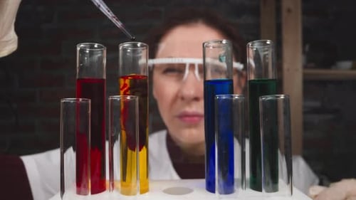 Concentrated Lab Assistant Drips Blood Into Tube in Hospital