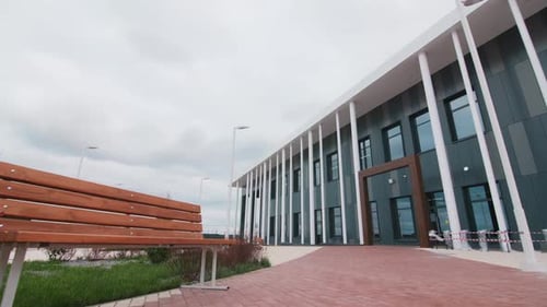 Motion Across Yard of Stylish New Building with Dark Facade