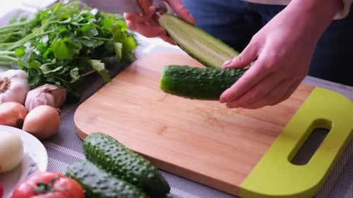 Cucumber Slices Being Prepared On Cutting Board