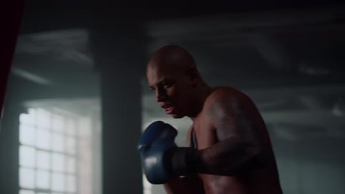 Man Practicing Boxing in Fighting Club