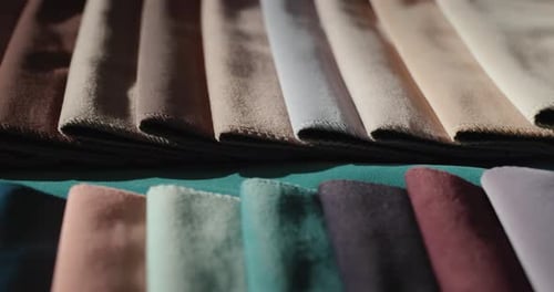 Samples of Multicolored Fabric on the Counter in the Store