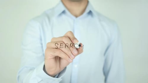 Man Writing the Word Search on Clear Surface