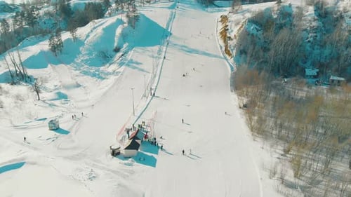 Track with Ski Lift on Snowy Hill on Winter Day Upper View
