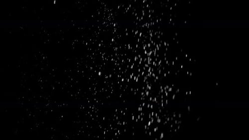 White Particles Falling on Black Background