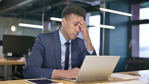 Tired Young Businessman Having Headache in Modern Office