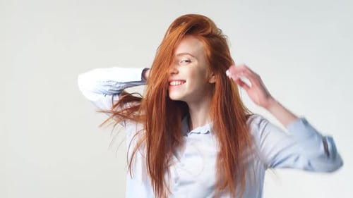 Woman with Red Hair Tossing Hair and Smiling