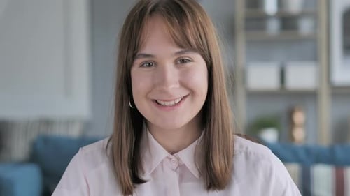Smiling Woman Looking at Camera in Home Setting