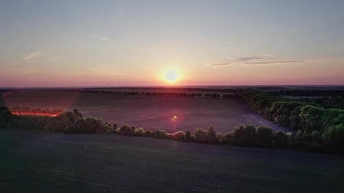 Beautiful Sunset Sky Over a Green Meadows