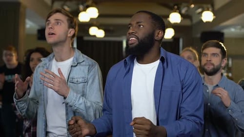 Enthusiastic Friends Watching Event at Indoor Bar