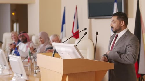 Man Giving a Speech at International Conference