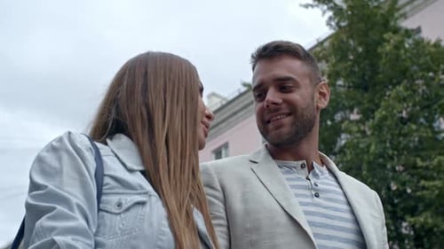 Smiling Couple Walks and Talks in City