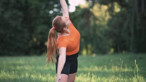 Woman Practices Yoga Poses Outdoors in Nature