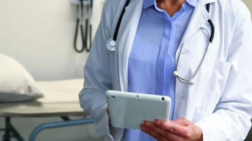 Female Doctor Using Tablet in Medical Office