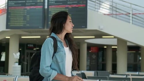 Woman Standing in a Modern Airport Terminal