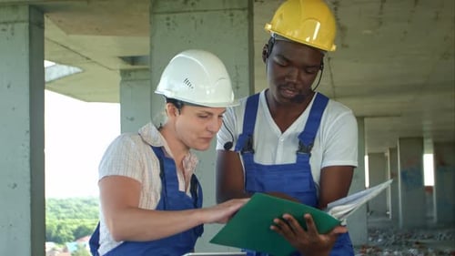 Workers Working on Building Site with Tablet