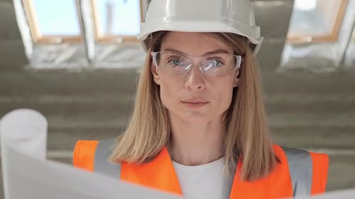 Portrait of Focused Talented Pretty Female Architect Looking at Camera