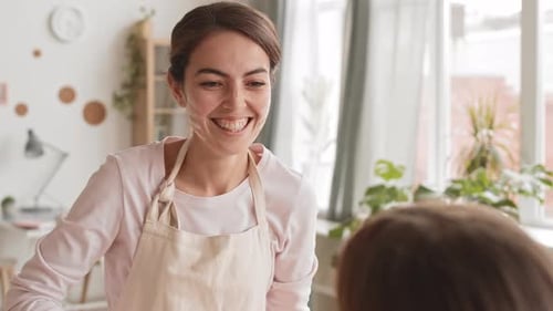 Smiling Woman with Child in Bright Home Interior