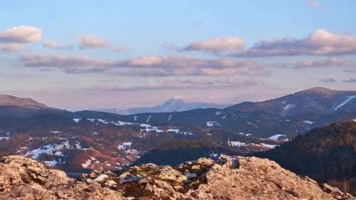 Densely Forested Mountain Landscape at Golden Hour Clouds in the Blue Sky
