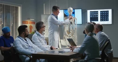 Medical Professionals Discussing X-Ray and Skeleton