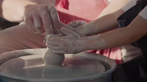 Hands Shaping Clay on a Pottery Wheel