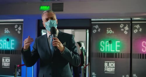 Adult Speaking into Microphone at Black Friday Event