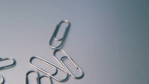 Paperclips Scatter on Light Grey Background