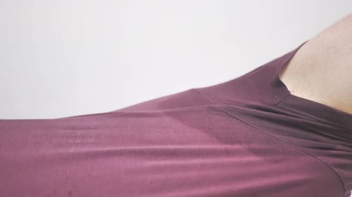 Armpit Sweat Patch on Maroon Shirt Close Up
