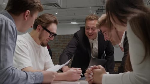 Team Working Together Around Table in an Office