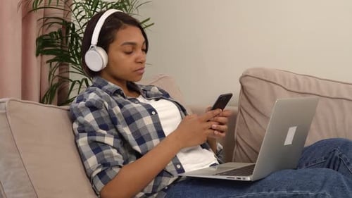 Woman Relaxing with Laptop and Mobile Phone