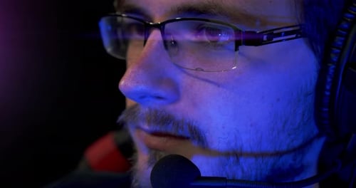 Intense Gamer with Headset Close Up at Night