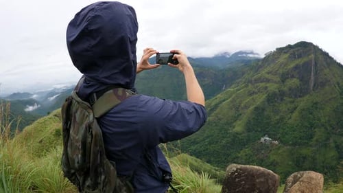 Active Hiker Man Takes Photo With Smartphone Of Mountain Top
