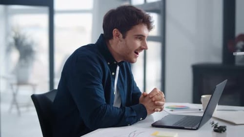 Excited Man Reacting to Good News on Laptop