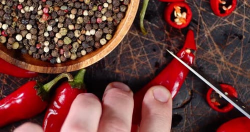 Men's Hands Cut Off From Red Chili Peppers Little Pieces.