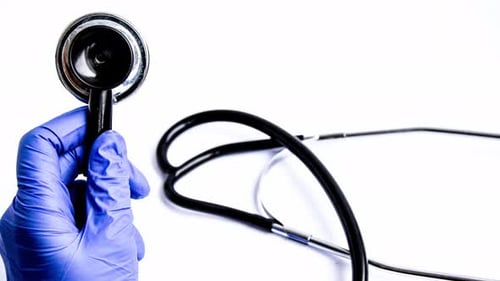 Stethoscope Held by Blue Gloved Hand, Close Up