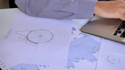 Unrecognizable Business Man Entering Data on Computer