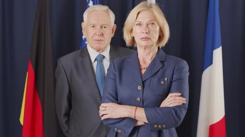 Formally Dressed Man and Woman Standing with Flags