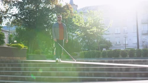 Young Blind Man with with a Cane Alone Outdoors