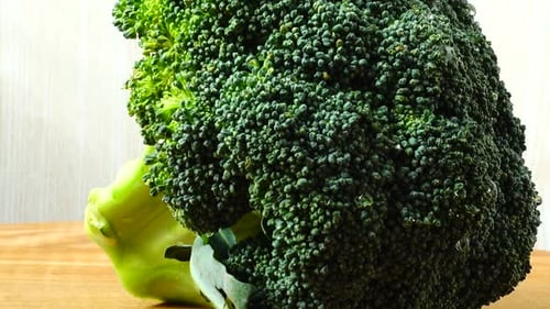Vibrant Broccoli Head on a Wood Cutting Board