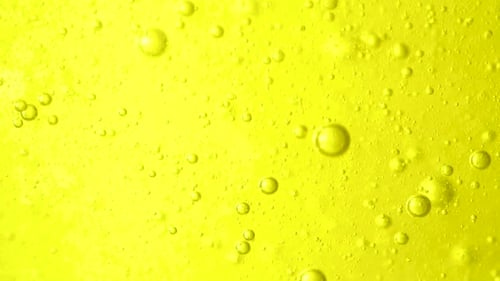 Abstract colorful background. Foam of Soap with Bubbles moving macro shot. Lemon bubbles in water