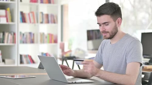 Man Shopping Online with Laptop and Credit Card