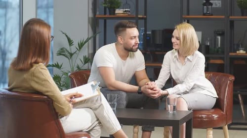 Couple Holding Hands in Therapy Session