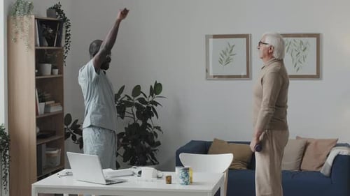 Senior Man Exercises with Medical Professional at Home