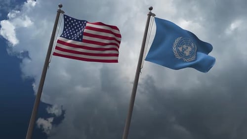 US and UN Flags Waving in Cloudy Sky