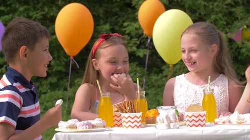 Happy Kids on Birthday Party at Summer Garden