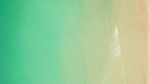 4K Aerial view top view of drone, sea waves and beautiful sand beach.
